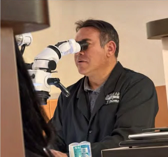 Dr. Solomon at a dental microscope